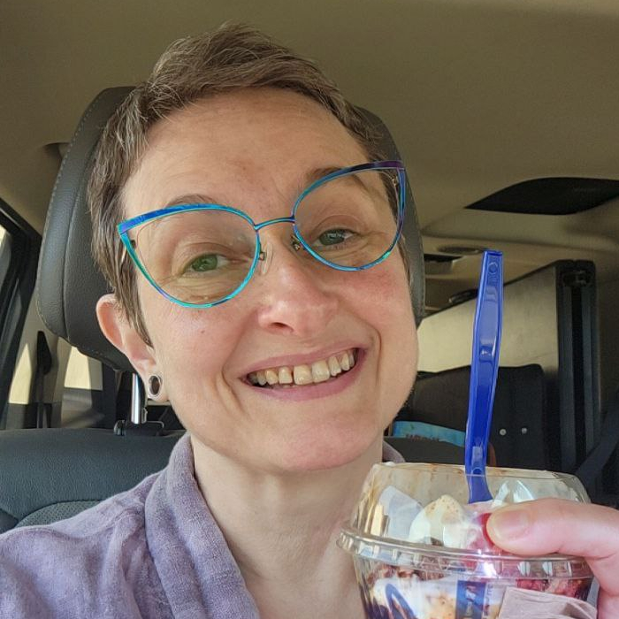 photo of woman with short hair holding an ice cream sundae